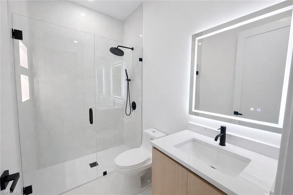 Full bath featuring vanity and a stall shower