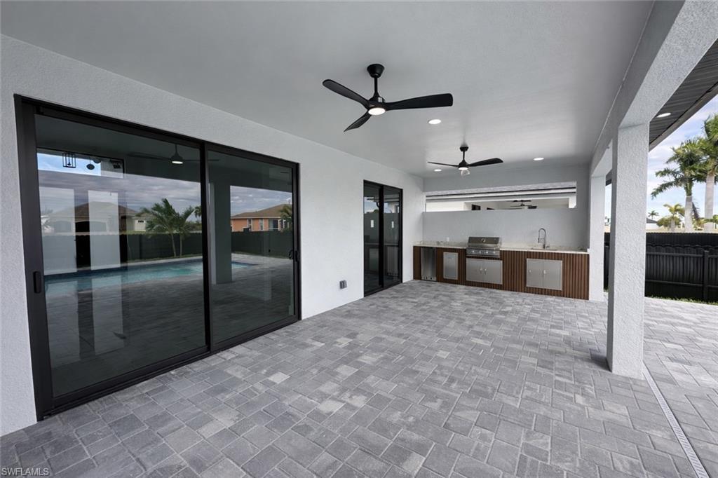 View of patio / terrace featuring an outdoor kitchen and a ceiling fan