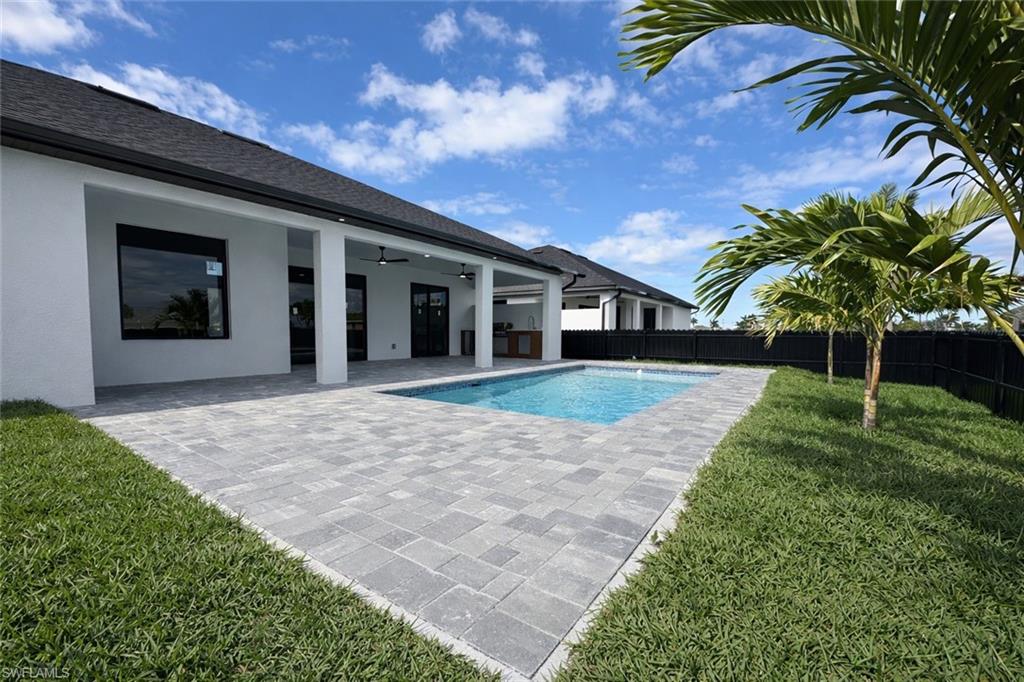 View of pool with patio surround and a fenced backyard