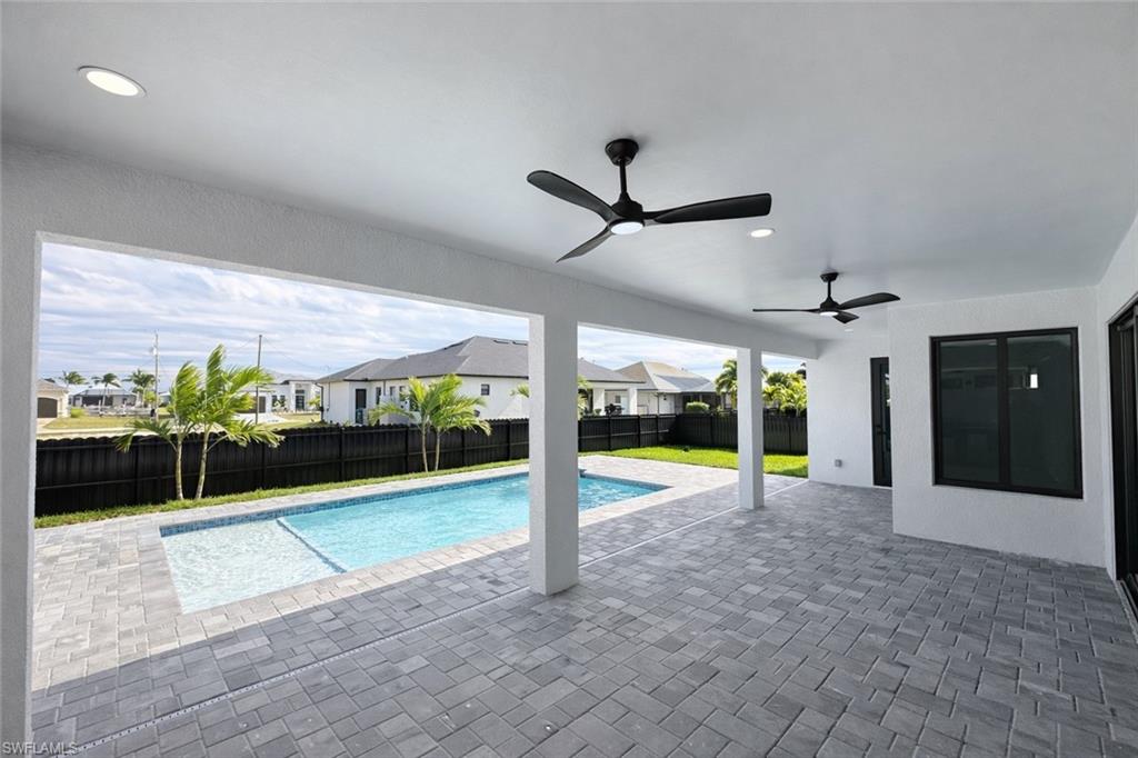 View of pool featuring a residential view, patio surround, and a fenced backyard