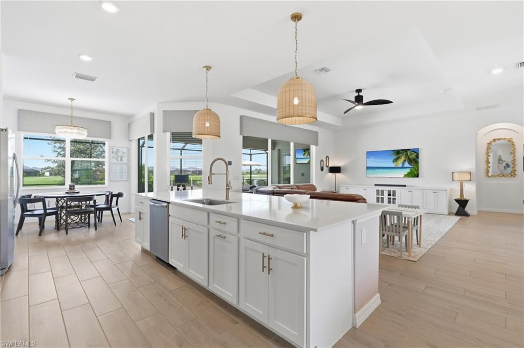 Gourmet kitchen with an expansive island, white shaker cabinetry, and Frigidaire Gallery appliances