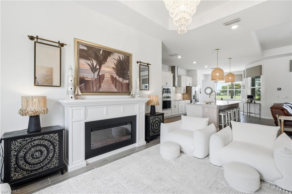 Dining area with amazing view of pool, water, golf course and poinciana tree