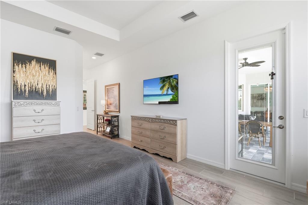 Dual vanity with white cabinetry, soaker tub, and walk in shower