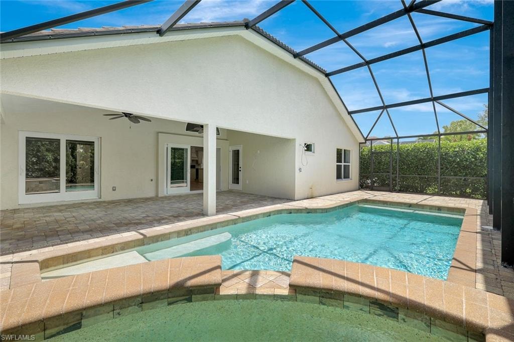 Screened lanai featuring a swimming pool, integrated spa, and paved decking