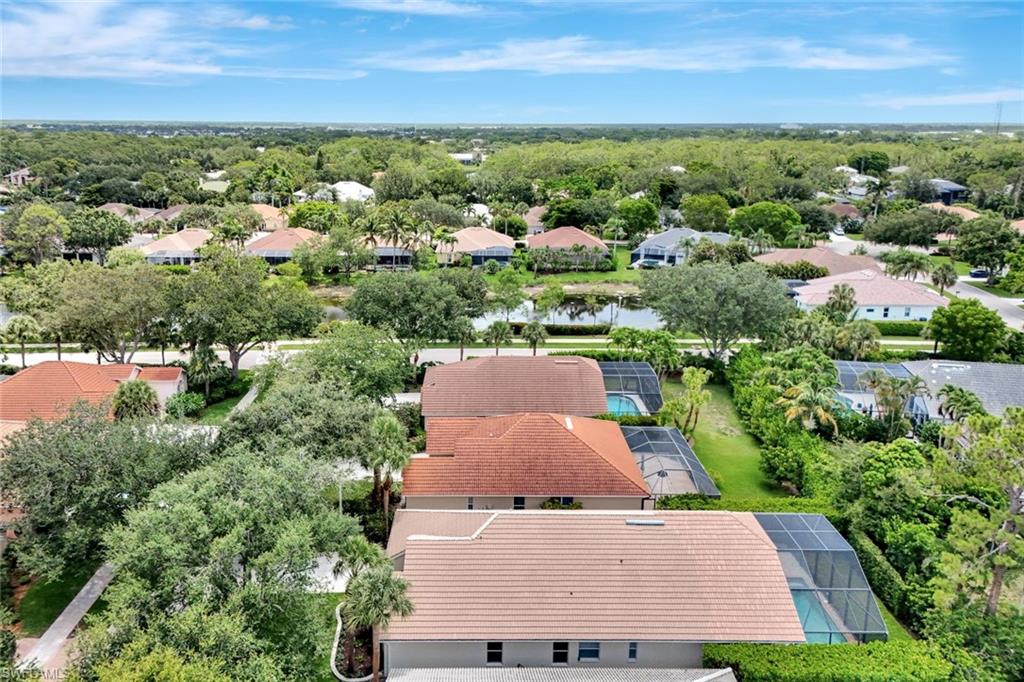 Tile roofs and screened pools complement the lush, established landscaping and water features in this community