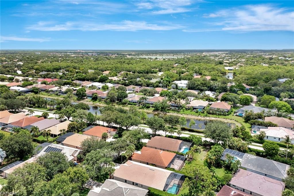 Residential community with mature tree canopy and multiple water features