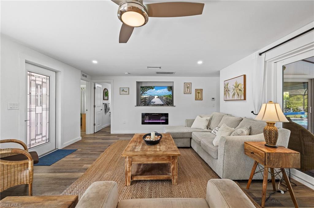 Wood-finish flooring throughout, with a decorative glass-paneled entry door