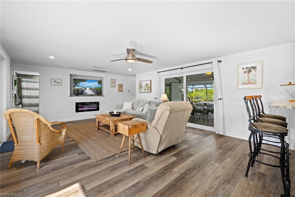 Wood-finish flooring throughout, recessed lighting, and a ceiling fan