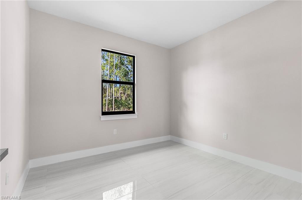 Recessed lighting, light gray wall finish, white baseboards, and light-toned tile flooring