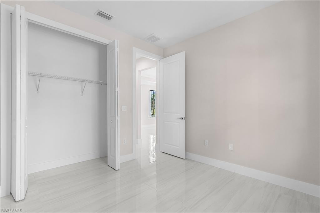 Light-toned walls, white trim, and white bi-fold closet doors