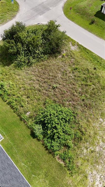 Expansive land parcel with surrounding paved roads, and lush green areas