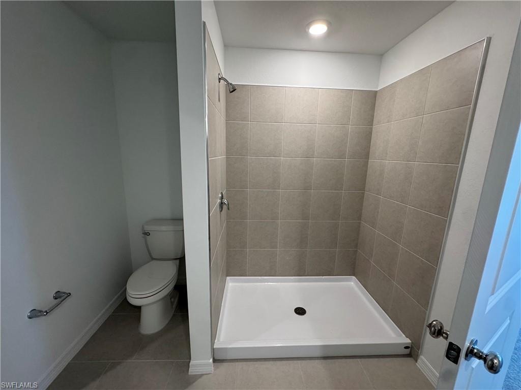 Walk-in shower with tiled walls and a white shower base