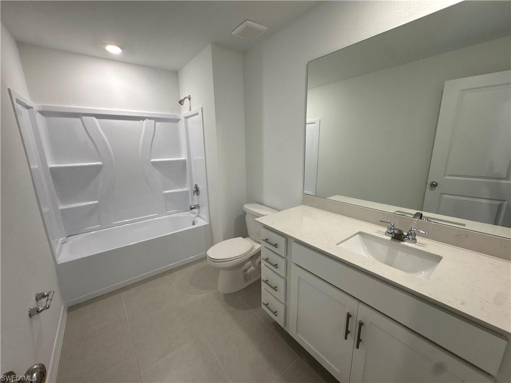 White vanity with an integrated sink, polished chrome faucet, and substantial wall-mounted mirror