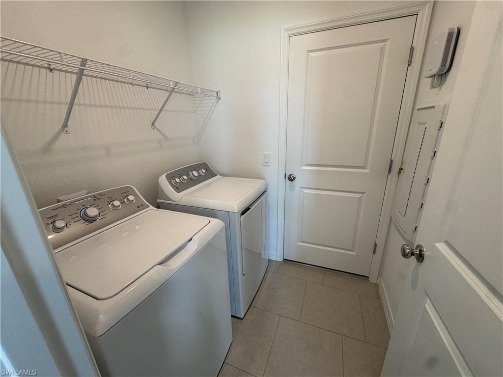 Laundry area featuring tile flooring and overhead wire shelving
