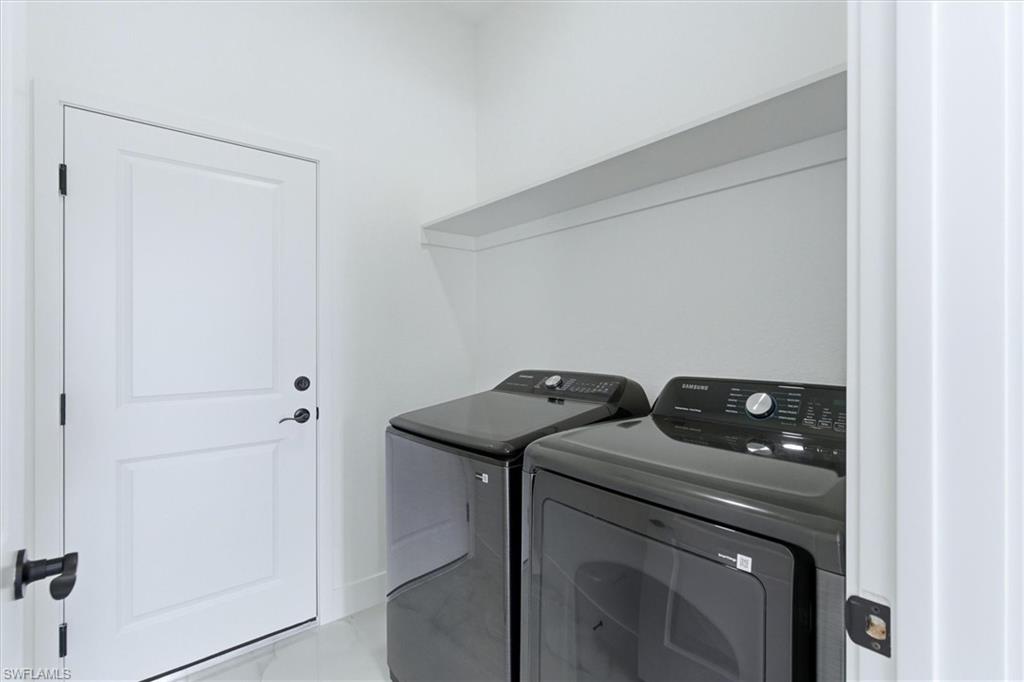 White paneled door with matte black hardware, integrated shelving, and tile flooring