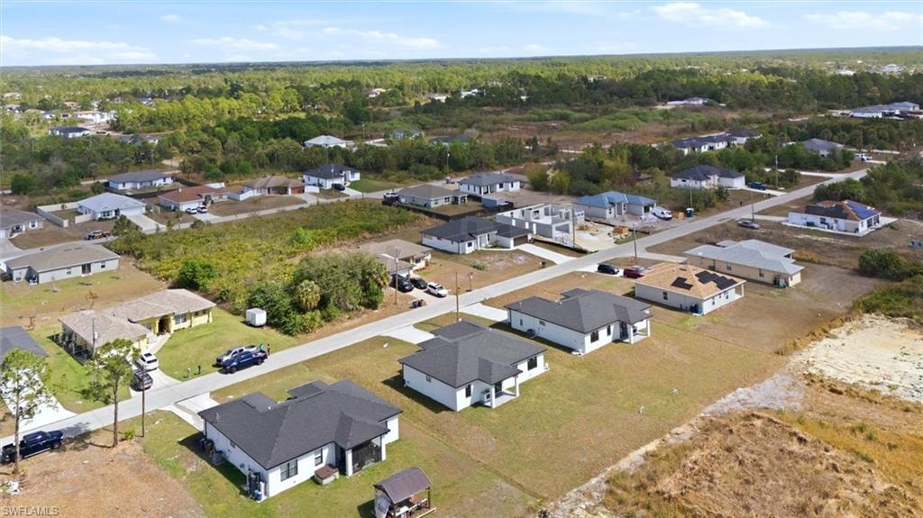 Developing residential area featuring single-story homes, paved streets, and a mix of completed and under-construction properties
