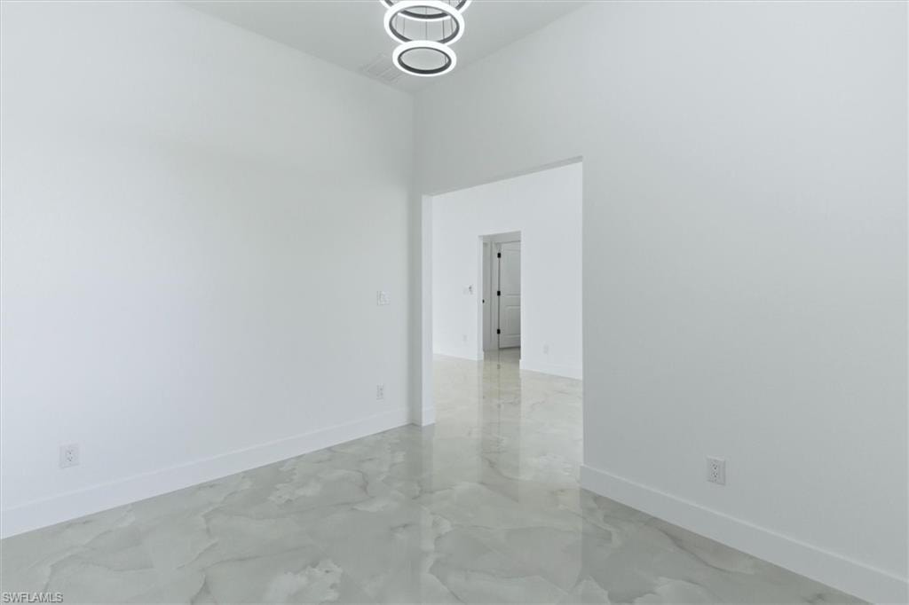 Recessed lighting fixtures, vaulted ceiling, tile flooring, modern chandelier, solid core interior doors
