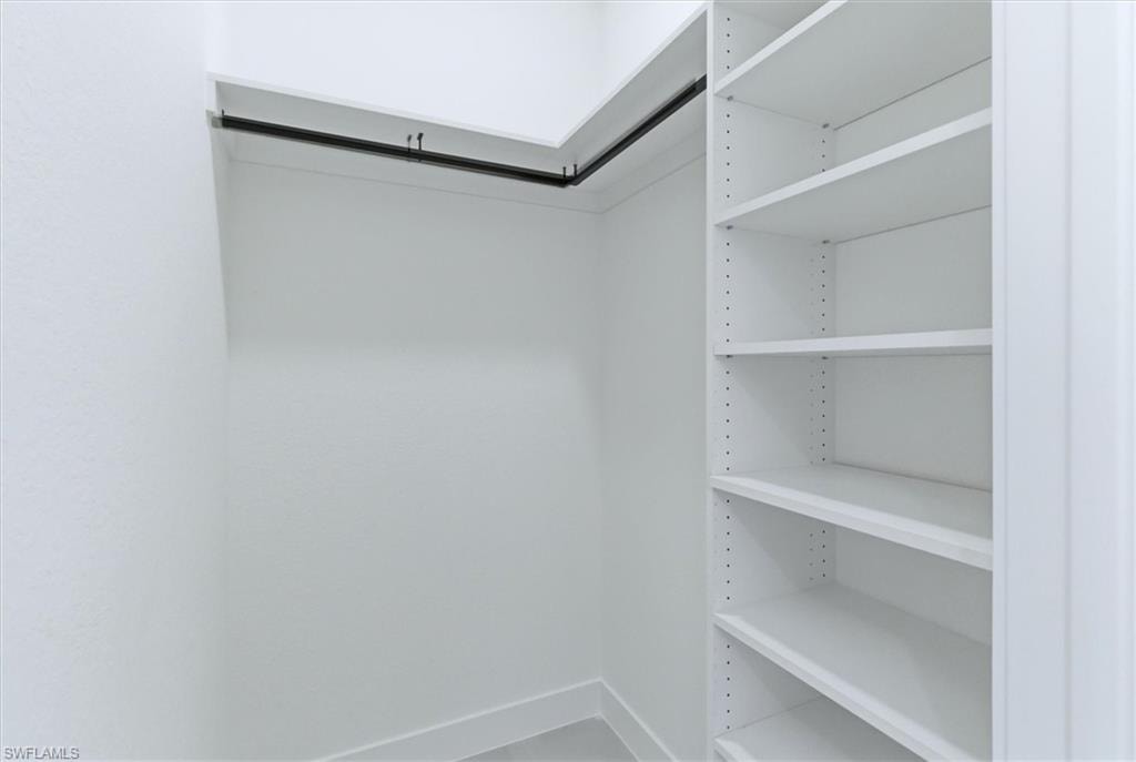 Built-in shelving system with adjustable shelves and a hanging rod