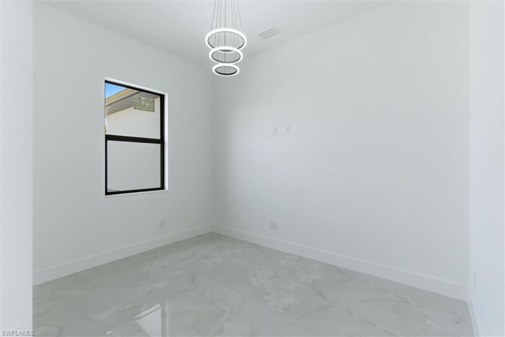 Polished tile flooring, modern circular pendant lighting, and a black-framed window