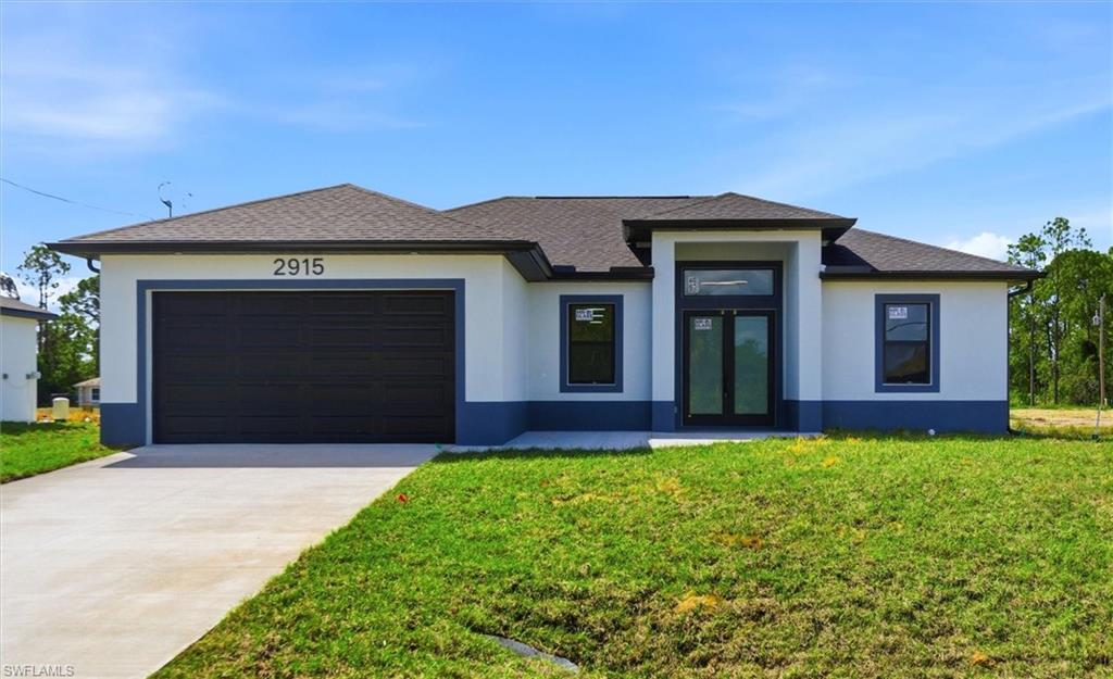 Contemporary stucco exterior with a dark shingle roof, two-car garage, concrete driveway, and covered entry