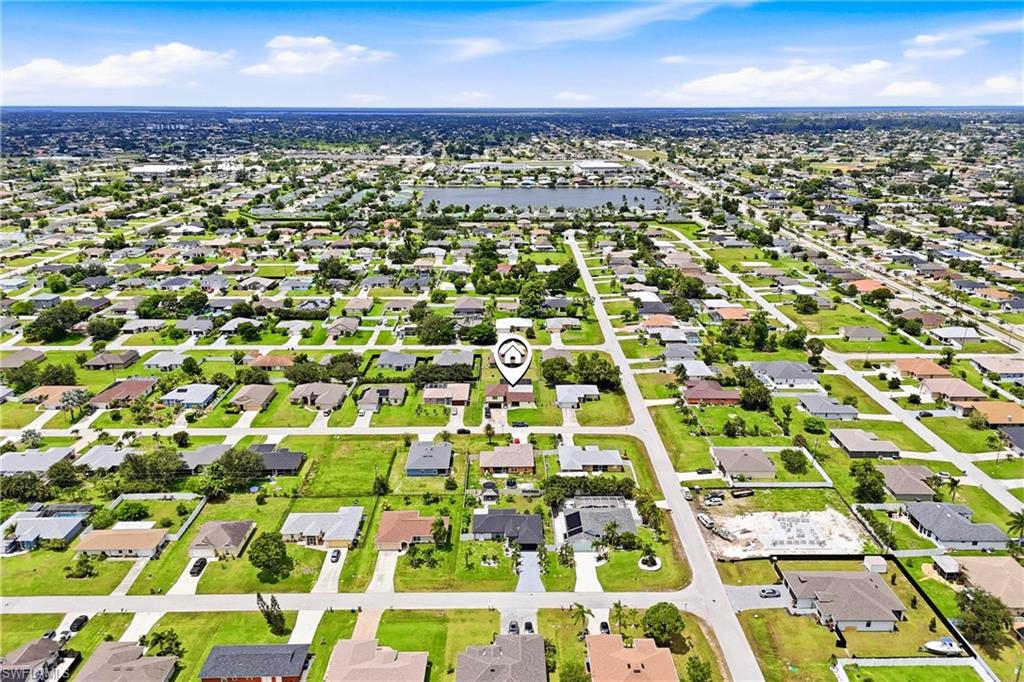 Bird’s-eye view highlighting this Cape Coral pool home and its desirable location.