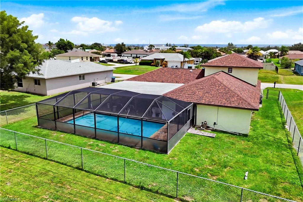 From above, see everything this property has to offer—spacious home, private pool, screened enclosure, and convenient location.