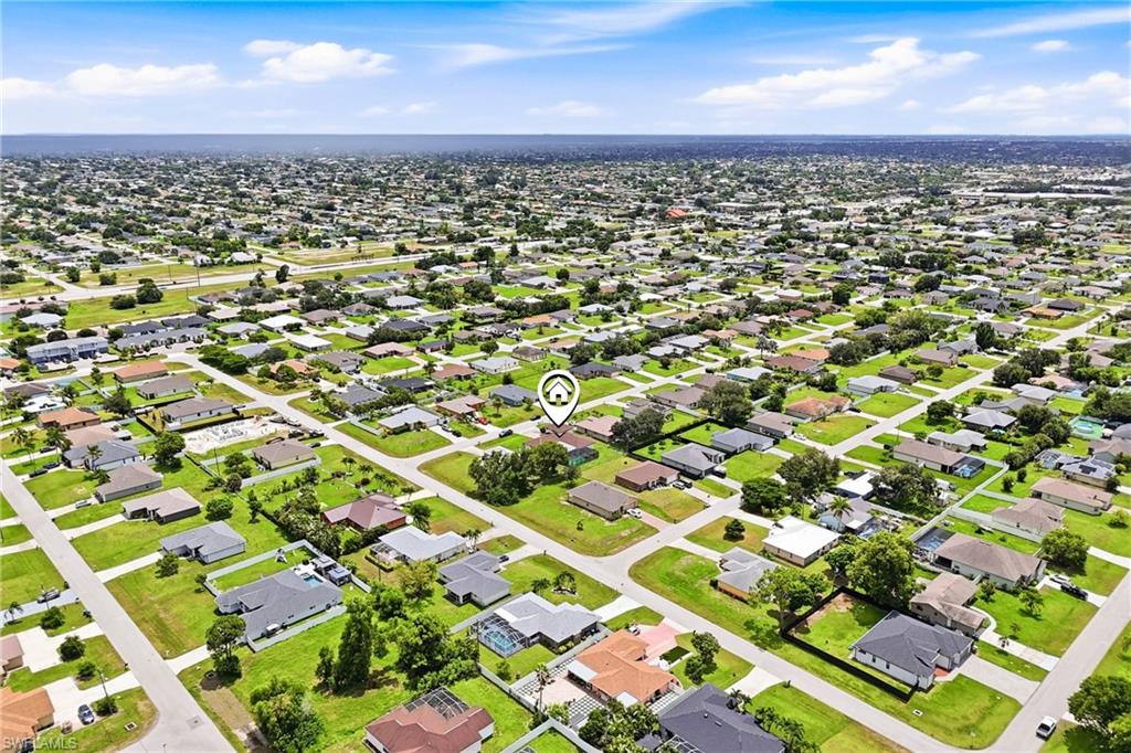 Location, lifestyle, and opportunity! This sweeping aerial view captures the complete package of this Cape Coral pool home