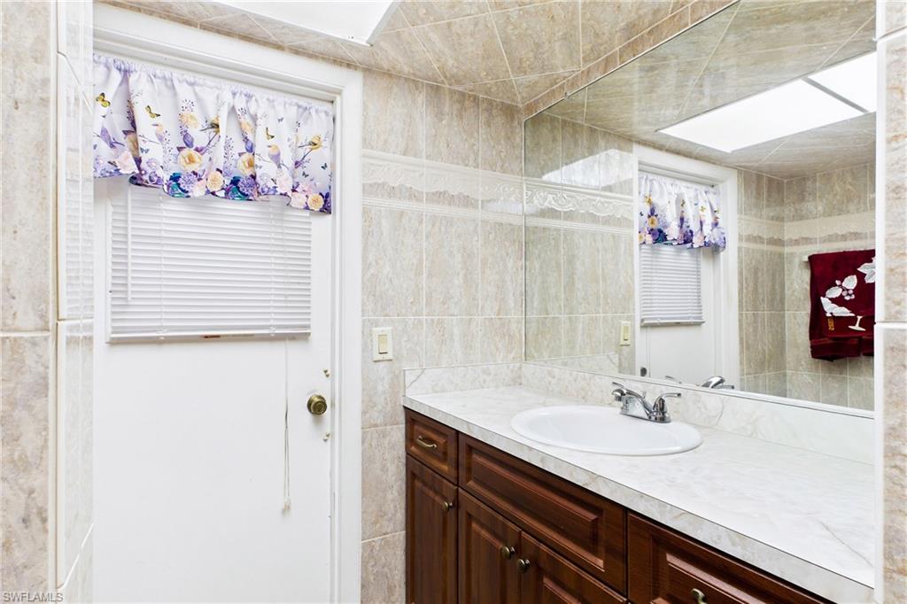 Convenient guest bathroom with direct outdoor access—perfect for pool days and entertaining!