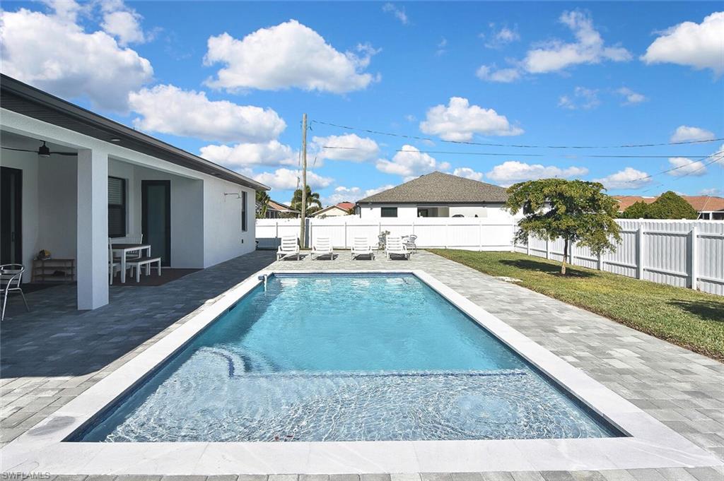 View of pool featuring a patio, a fenced backyard, and outdoor dining space