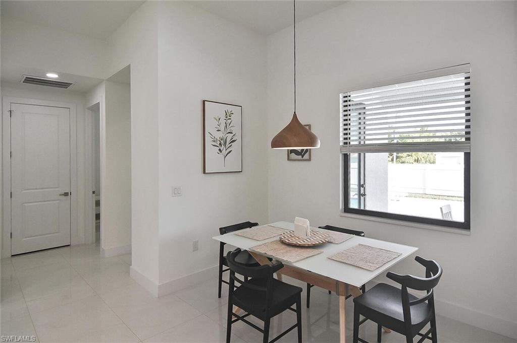 Dining space featuring baseboards and light tile patterned floors