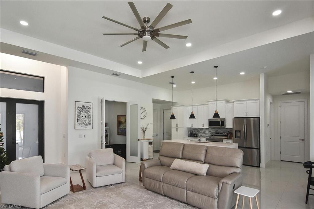 Living area with recessed lighting and ceiling fan