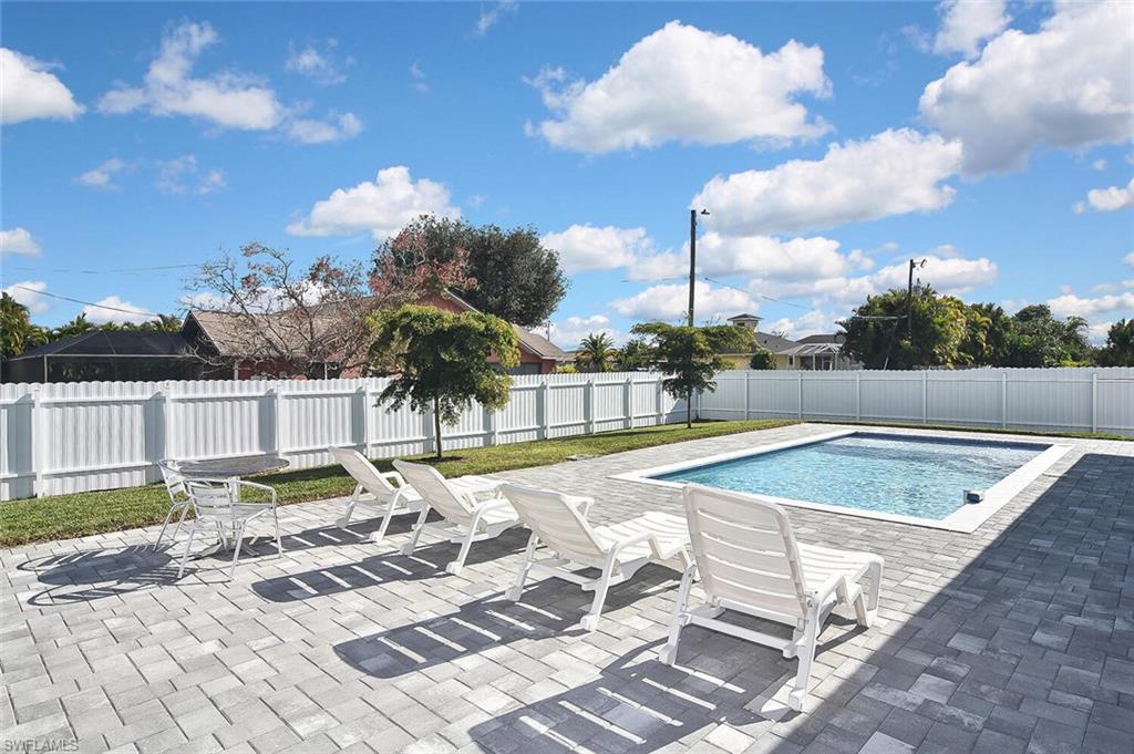View of swimming pool featuring a patio and a fenced backyard