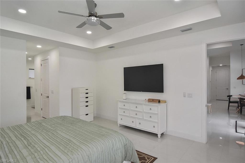 Bedroom with recessed lighting, ceiling fan, and connected bathroom