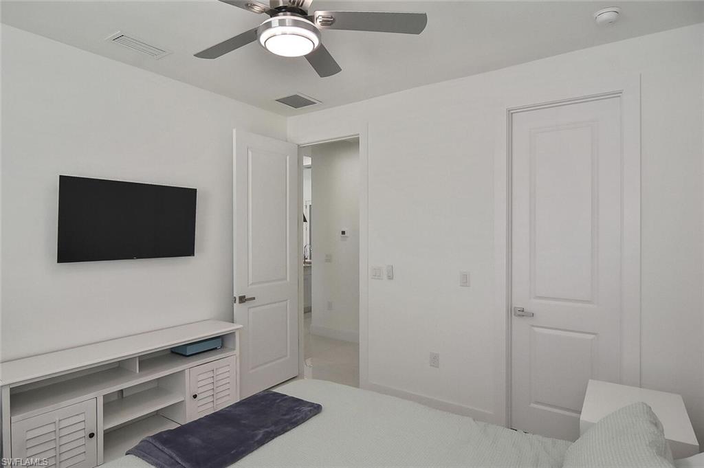 Bedroom with an office area and a ceiling fan