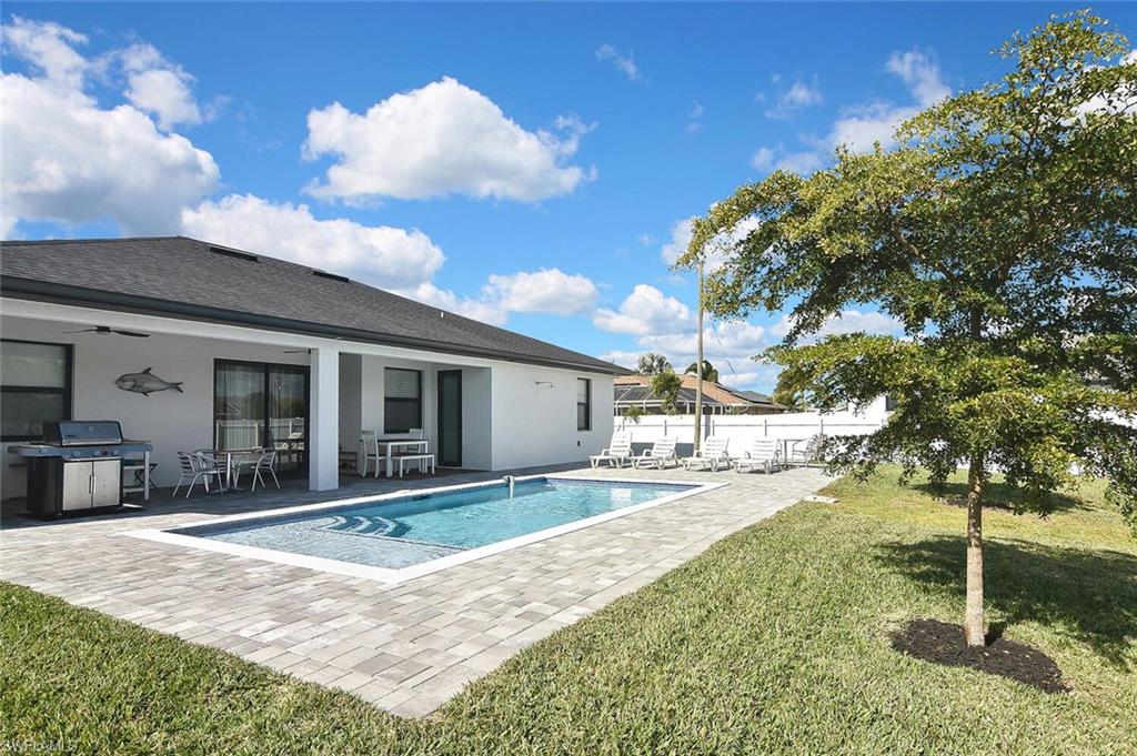 View of pool featuring a patio, grilling area, and outdoor dining area