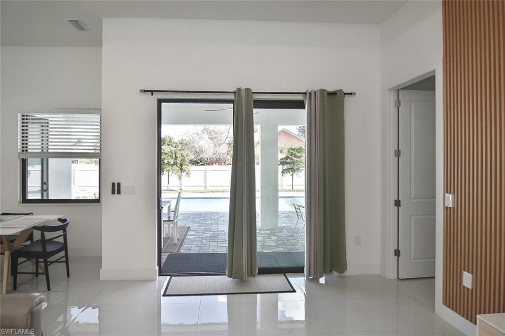Doorway featuring tile patterned flooring