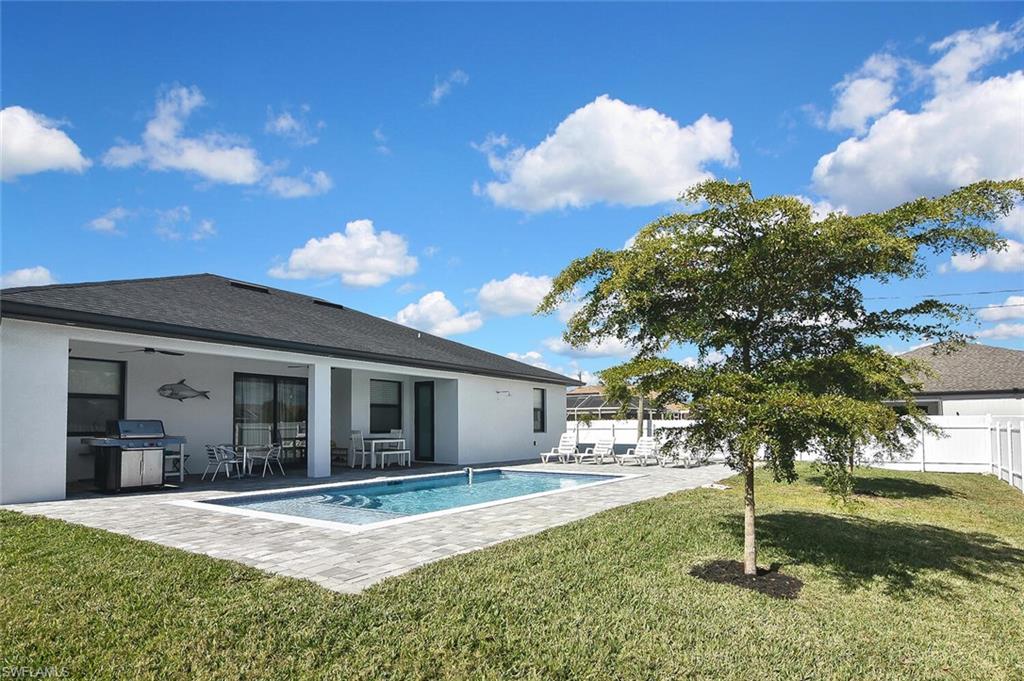 Back of house with a patio area, a ceiling fan, stucco siding, and a fenced backyard
