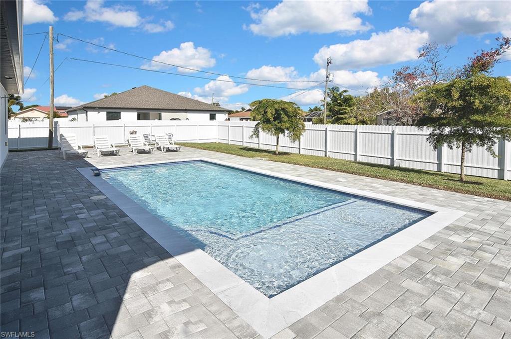 View of swimming pool featuring a patio area and a fenced backyard