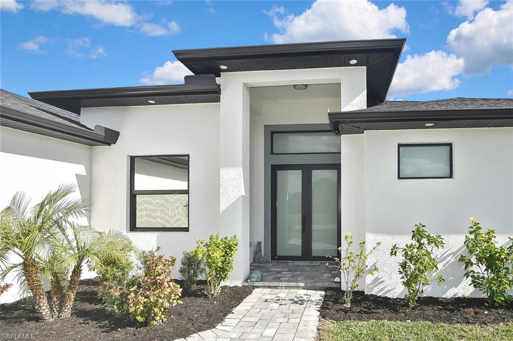Entrance to property featuring stucco siding
