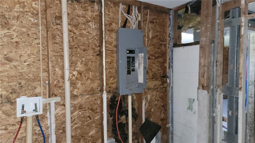 Electrical panel and exposed framing with plumbing lines