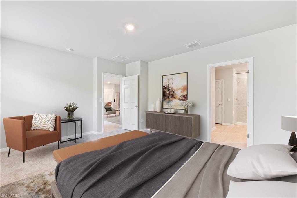 This image is virtually staged. Bedroom featuring light carpet and ensuite bathroom