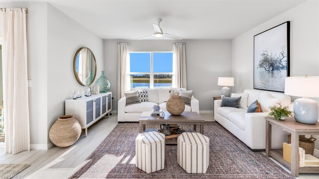 Model home. Living room featuring wood finished floors and a ceiling fan