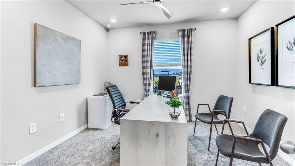 Model home. Office space with light carpet, ceiling fan, and recessed lighting