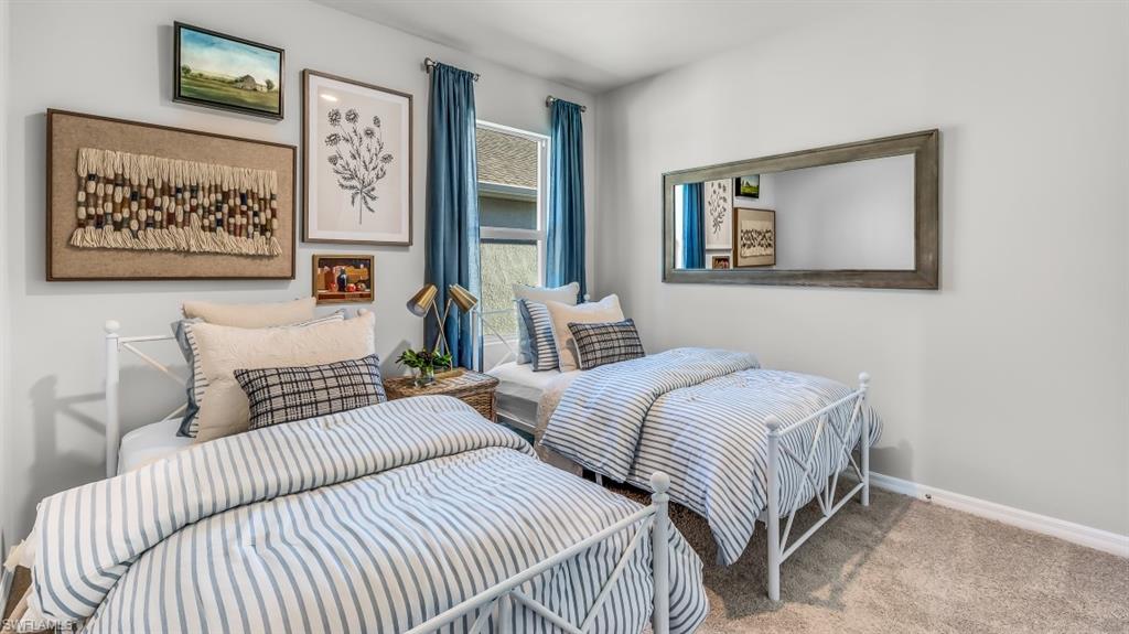 Model home. Bedroom with baseboards and carpet floors