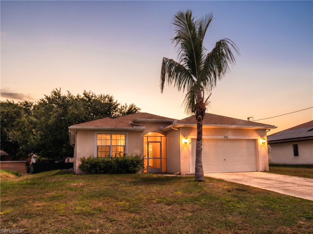 Stucco exterior with a single garage door and a concrete driveway
