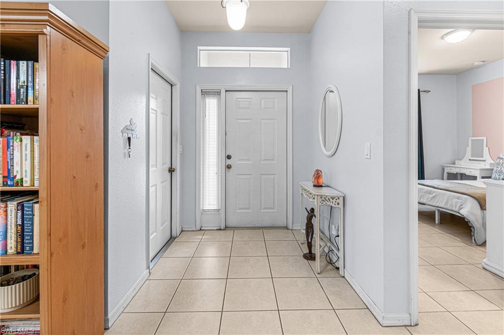 Entryway featuring tile flooring, a transom window, and multiple interior doors
