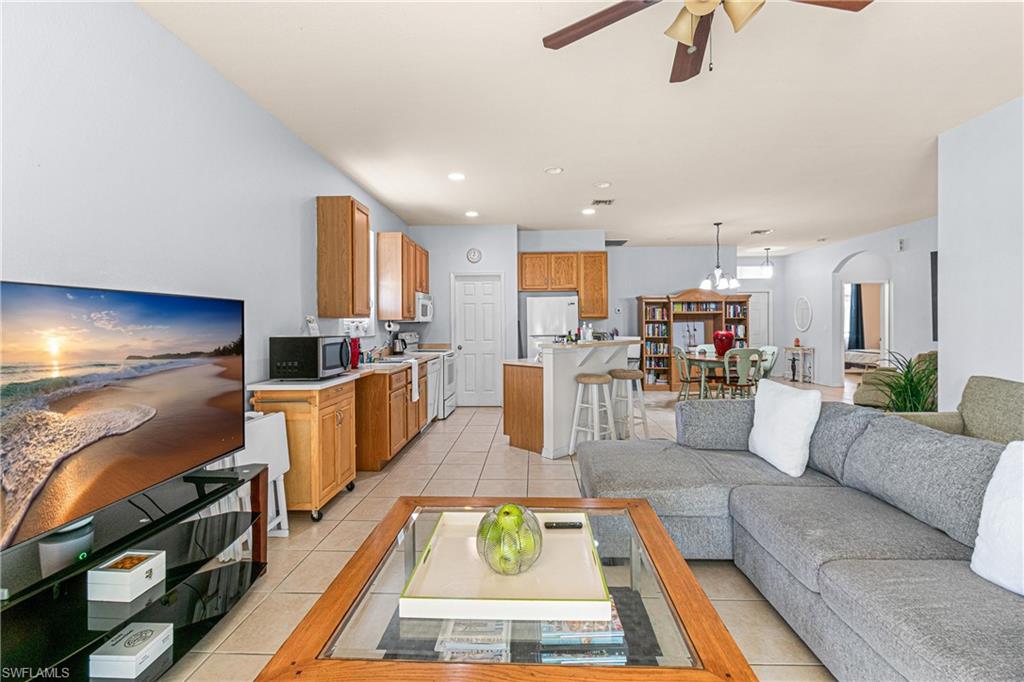 Open-concept living area with tiled flooring, a ceiling fan, and recessed lighting