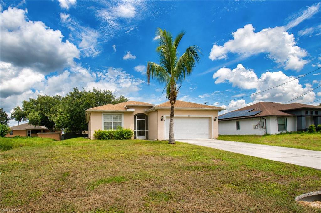 Single-story residence featuring a stucco exterior, attached garage, and a screened entryway