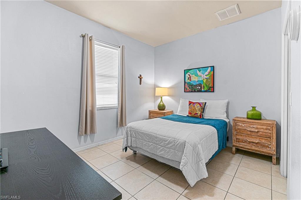 Recessed lighting, tile flooring, and a single window with blinds
