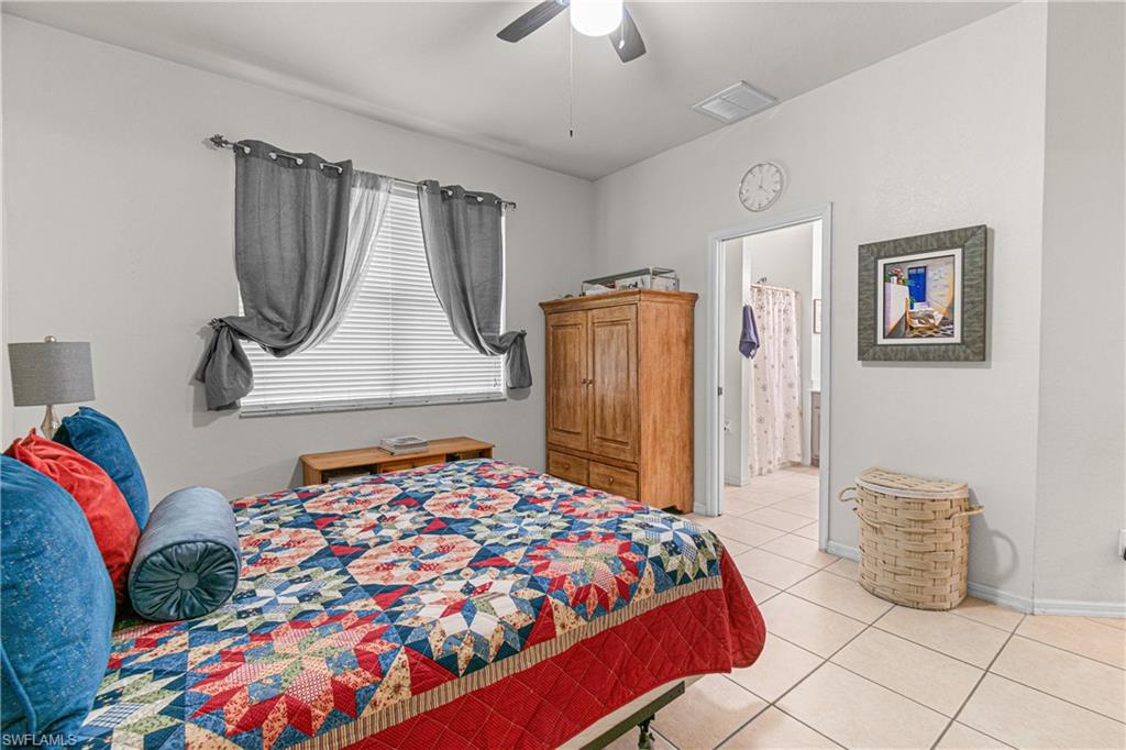 Room featuring tile flooring, a window with blinds, and a ceiling fan